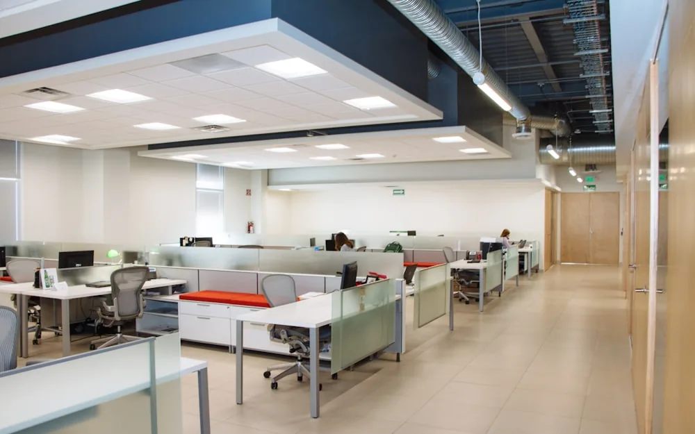 Rows of clean office desks in a modern workspace.