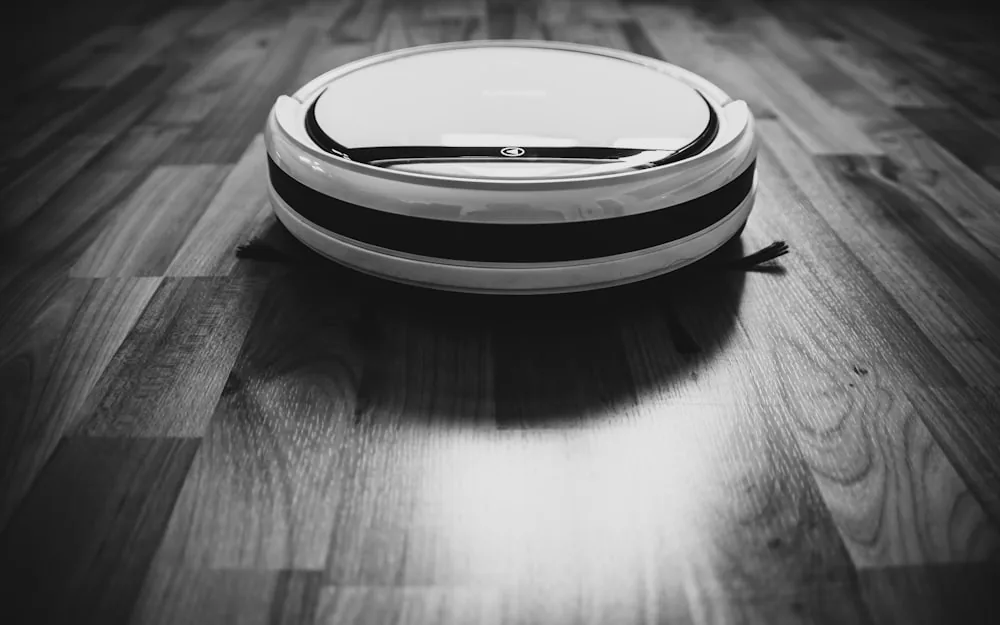 A vacuum cleaner being used on a carpeted floor.