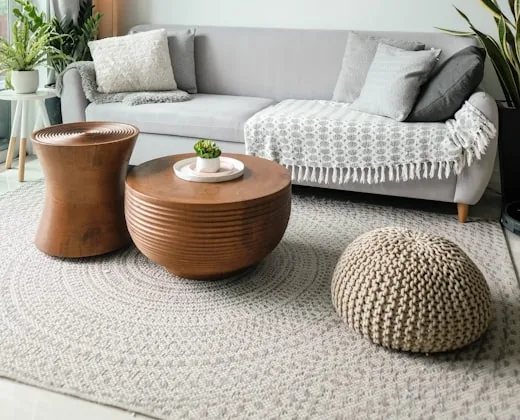 A freshly cleaned living room with a rug and coffee table.
